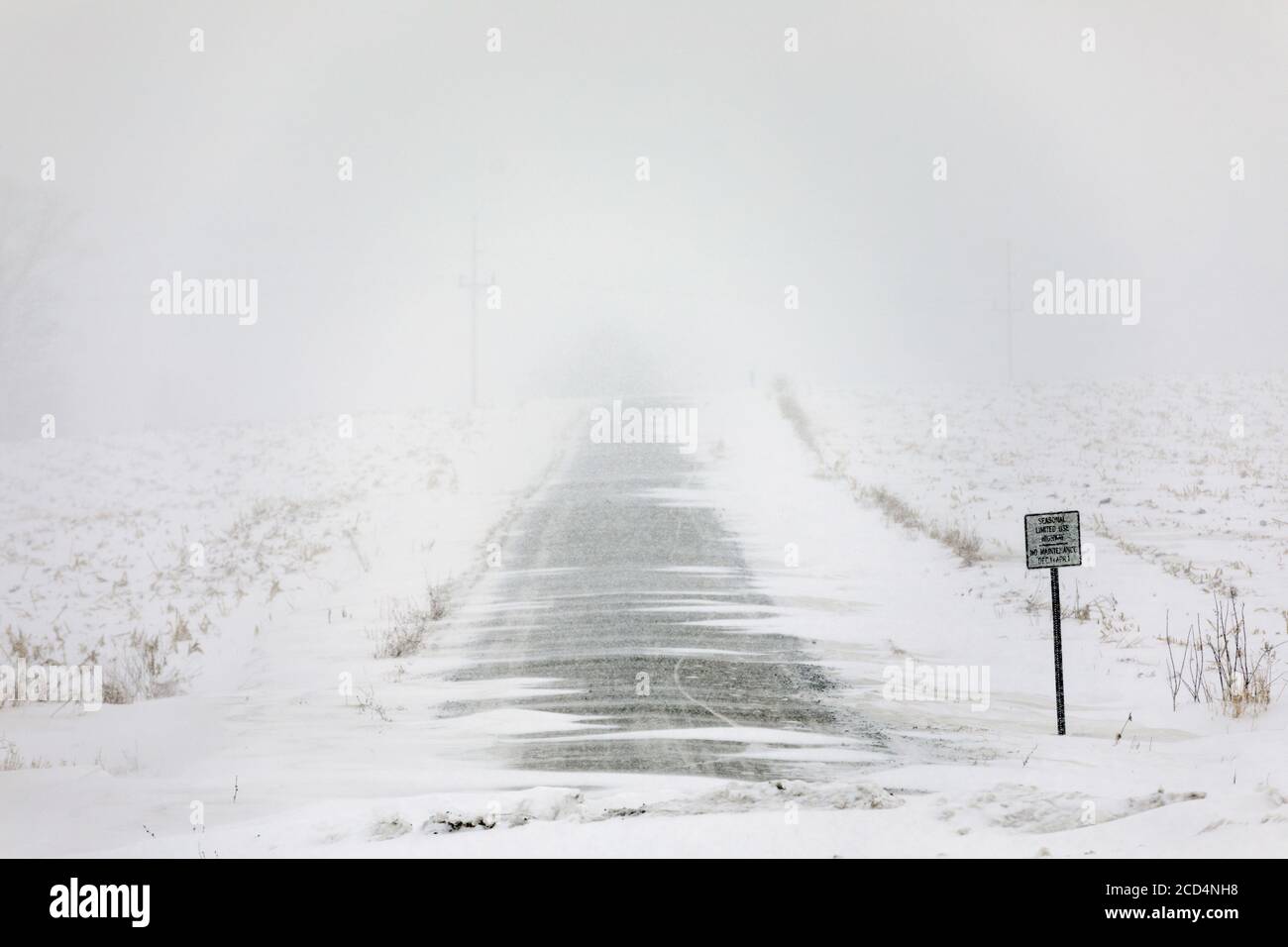 Mohawk Valley, New York State: A seasonal road during a snow storm,makes for difficult and dangerous travel. Stock Photo