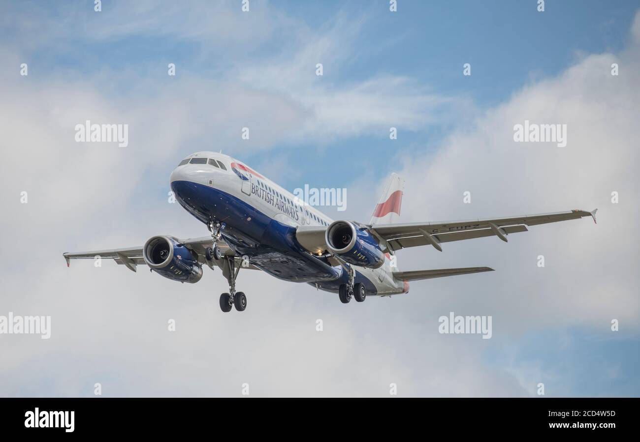 Heathrow Airport, London, UK. 26 August 2020. British Airways Airbus A319 G-EUPZ on approach to runway 27L at Heathrow in gusting wind. COVID-19 pandemic has seen the airline industry slump worldwide, with approx 11% of passengers at Heathrow in July 2020 compared with the same month in 2019, and approx 25% of air traffic movements at Heathrow in July 2020 compared with July 2019. Credit: Malcolm Park/Alamy. Stock Photo