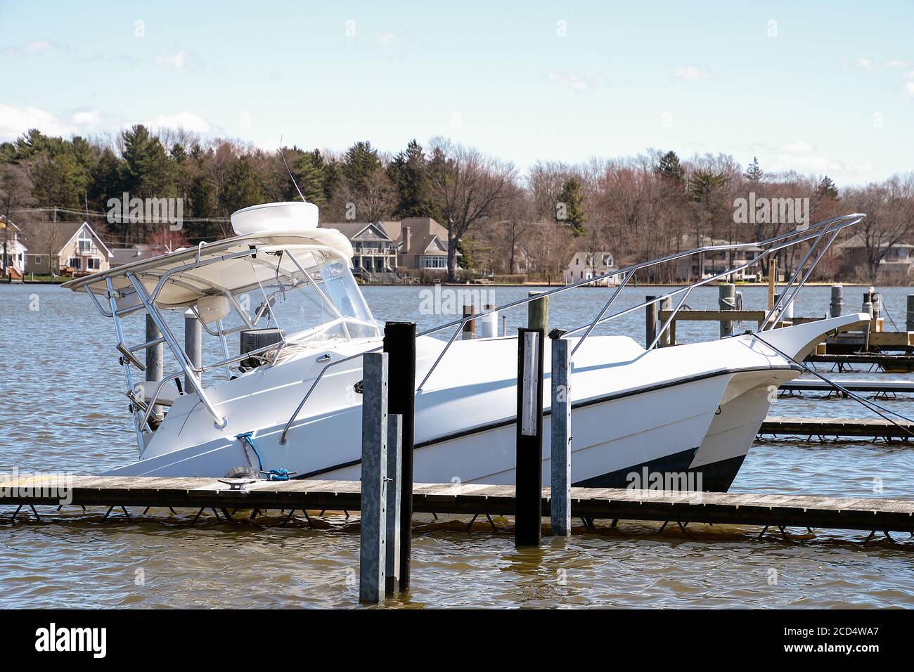 sinking white catamaran boat in marina boat slip Stock Photo