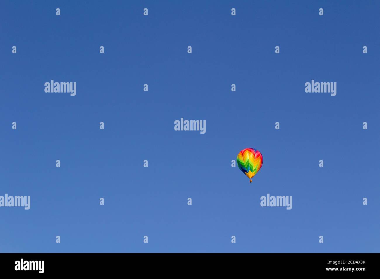 Colorful hot air balloon flying on blue sky Stock Photo - Alamy