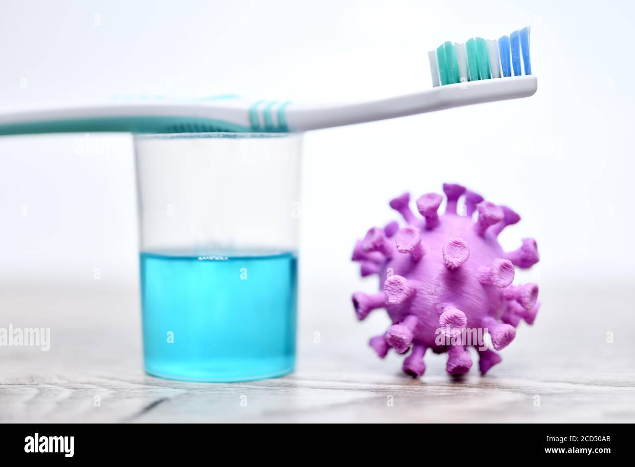 Coronavirus miniature, toothbrush and mouthwash Stock Photo