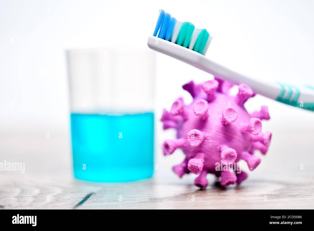 Coronavirus miniature, toothbrush and mouthwash Stock Photo