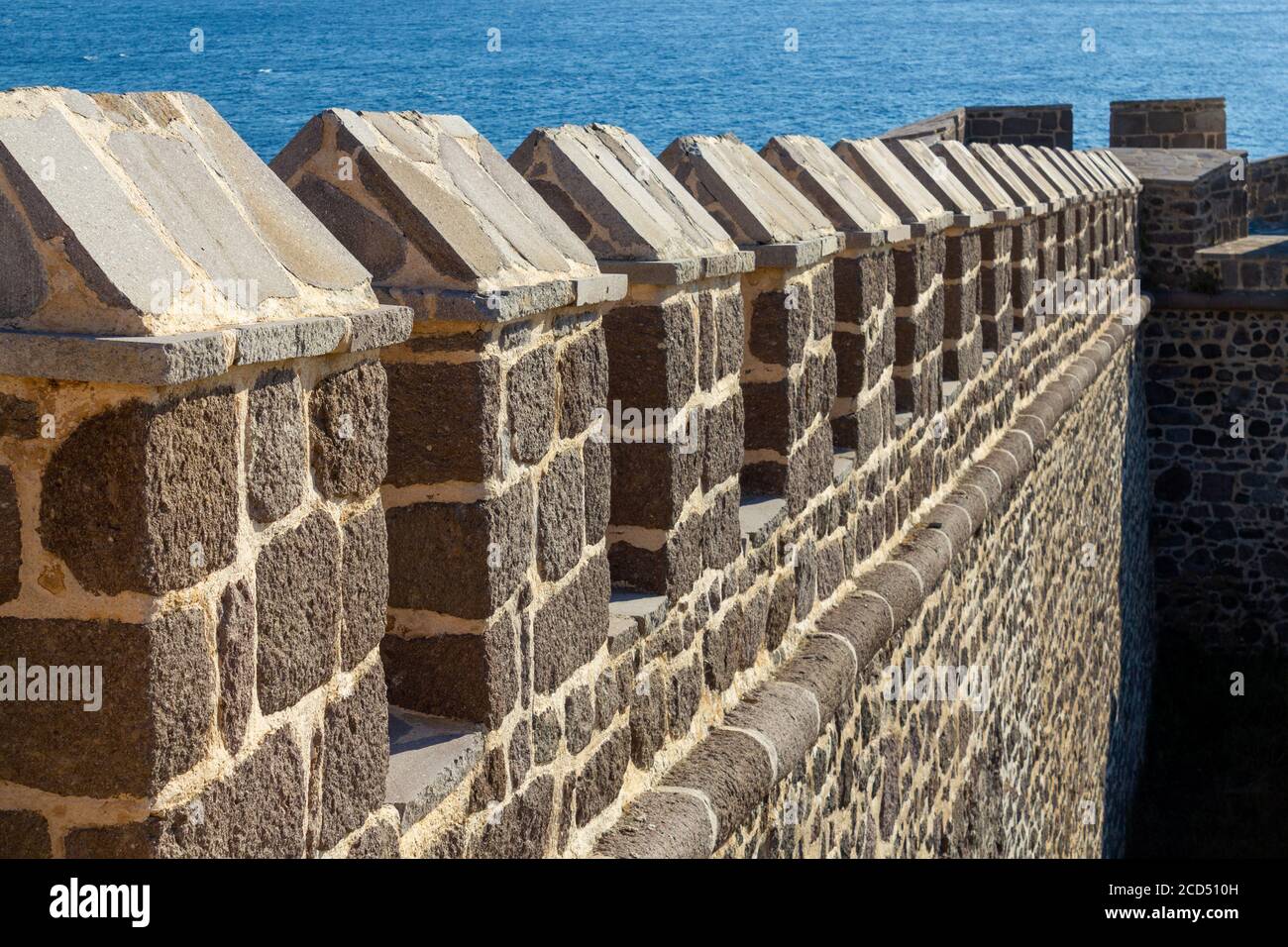 Castle defense wall and sea background Stock Photo