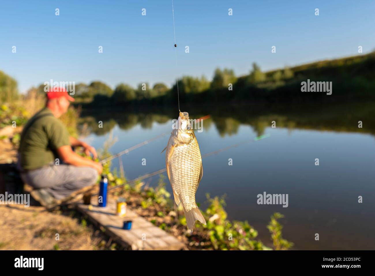 Fisherman baiting hook Stock Photo - Alamy