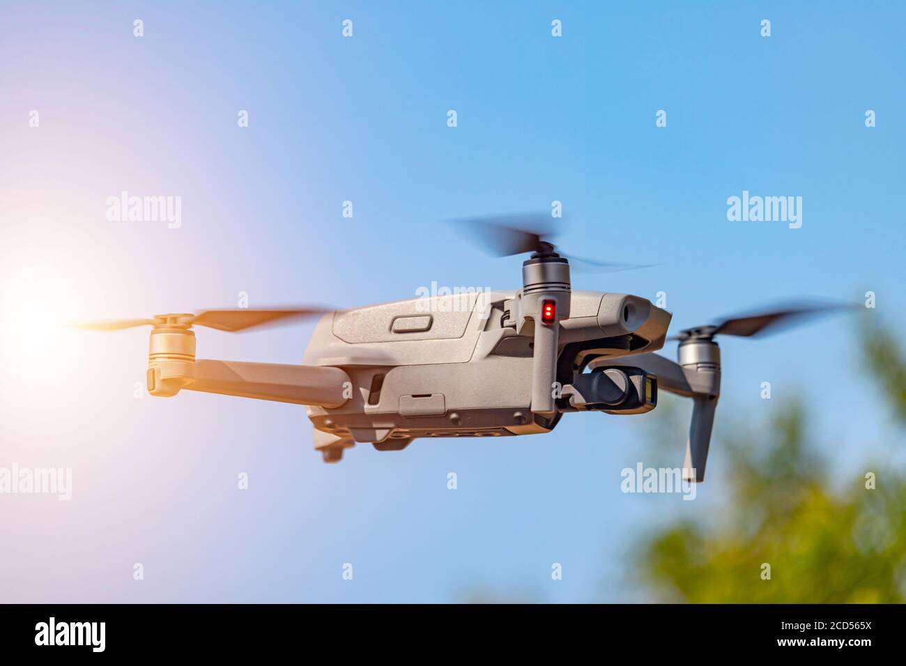 Drone with digital camera flying on sunny sky. Modern RC quadcopter Stock  Photo - Alamy