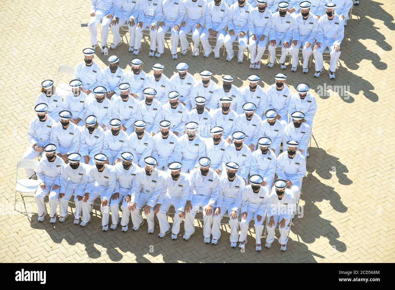 U.S. Naval Academy Navy midshipmen, wear PPE masks during the Oath of Office ceremony July 18, 2020 in Annapolis, Maryland. Oath Day marks the beginning of the shortened four-week indoctrination period called Plebe Summer, intended to transition the candidates from civilian to military life. Stock Photo