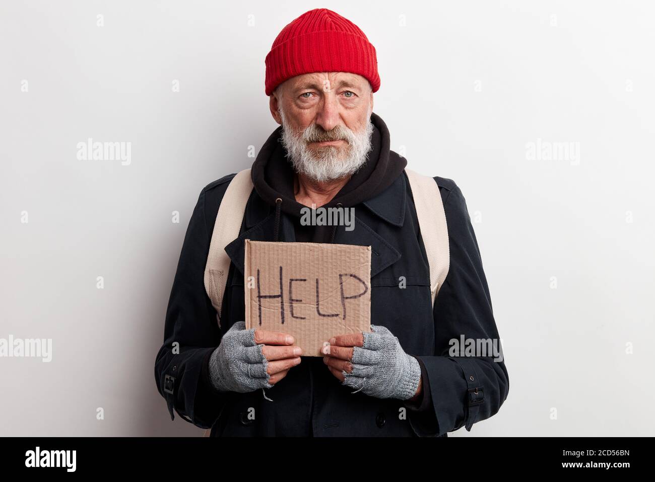 Homeless Man Holding Sign Request For Help Seeking Help Posing At Studio Over White Background Stock Photo Alamy