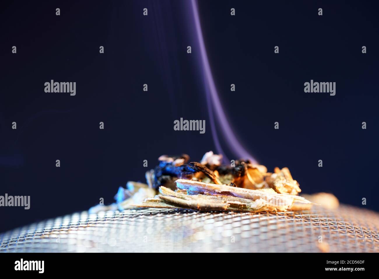 Closeup shot of burning muscatel sage on a dark background Stock Photo
