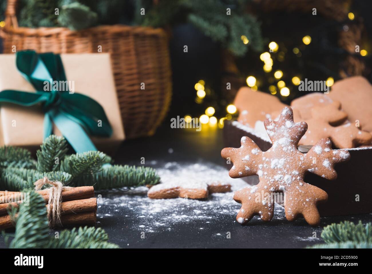 https://c8.alamy.com/comp/2CD5900/holiday-composition-of-tasty-homemade-cookies-gift-hamper-gift-and-garland-on-black-2CD5900.jpg