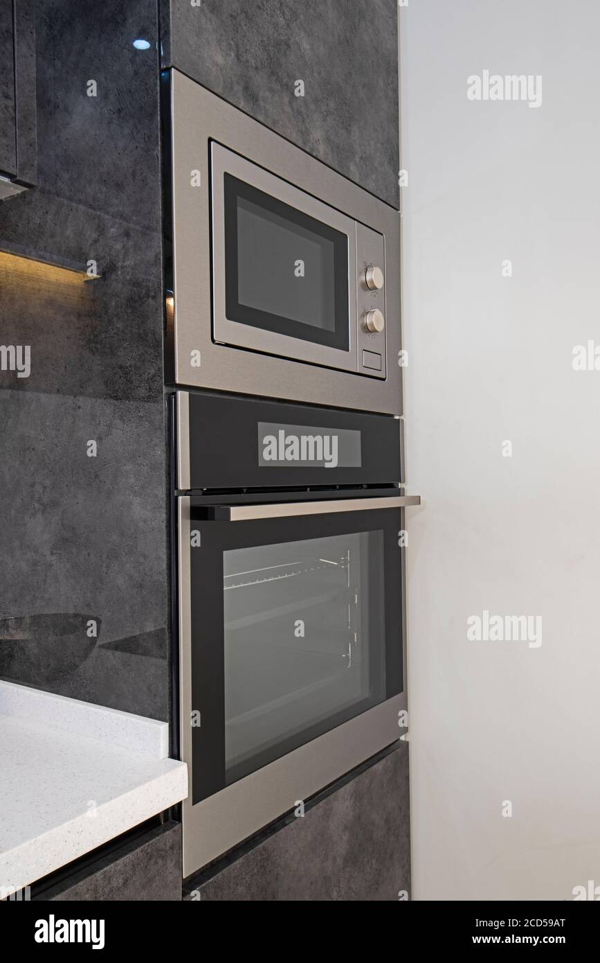 Interior design decor showing modern kitchen cooker oven with cupboards in luxury apartment showroom Stock Photo