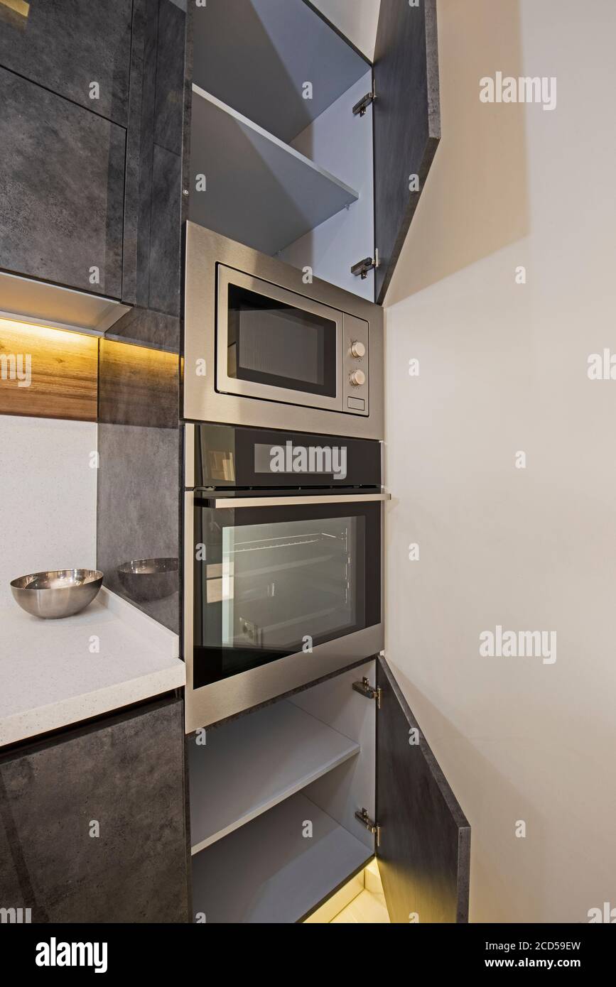 Interior design decor showing modern kitchen cooker oven with cupboards in luxury apartment showroom Stock Photo