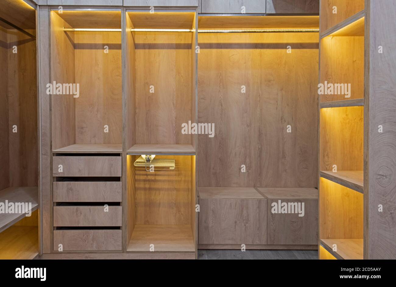 https://c8.alamy.com/comp/2CD5AAY/interior-design-decor-furnishing-of-luxury-show-home-bedroom-showing-walk-in-wooden-wardrobe-closet-furniture-2CD5AAY.jpg