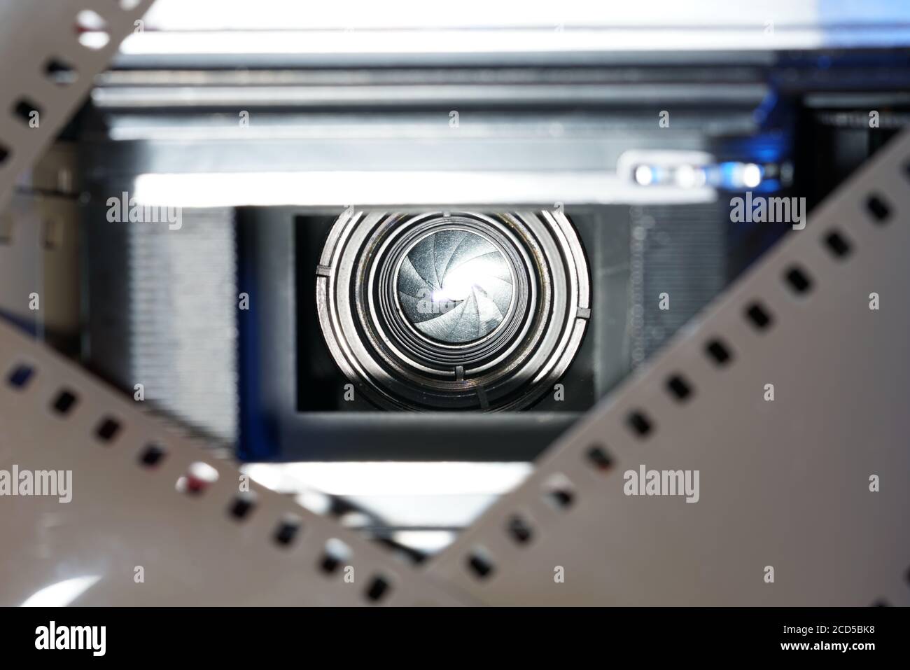 Closeup shot of a film camera seen through film strip frame Stock Photo