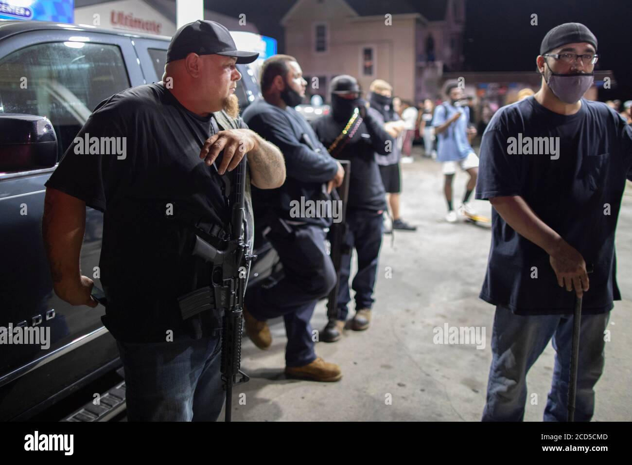 Kenosha, Wisconsin, USA. 25th Aug, 2020. Men stand at a gas station as
