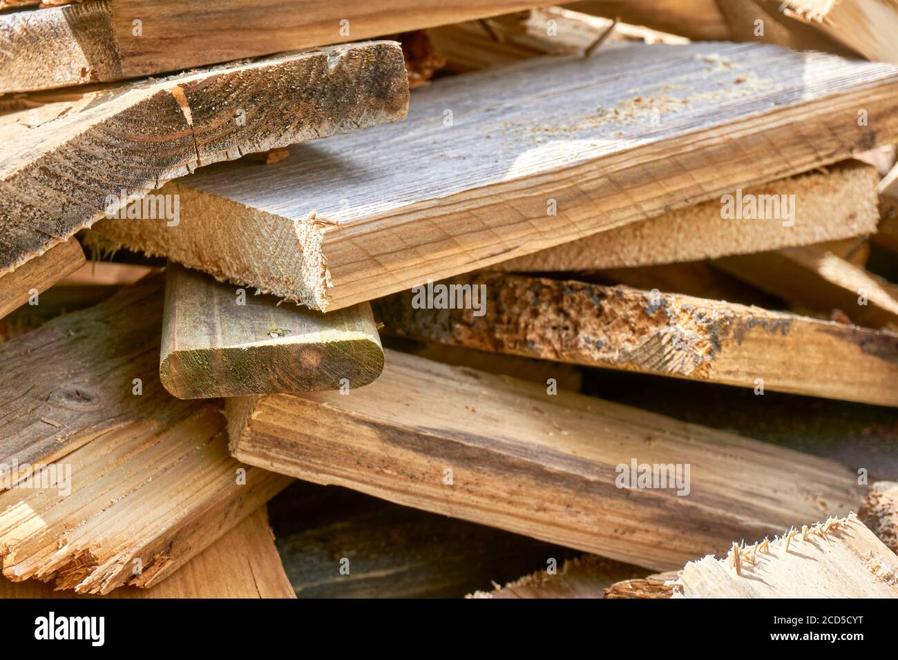 Closeup of a pile of old used timber planks. Wood waste background, wood trash. Stock Photo