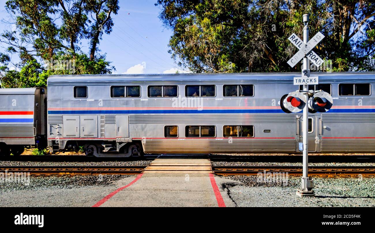 Passenger train and railroad crossing, California, USA Stock Photo