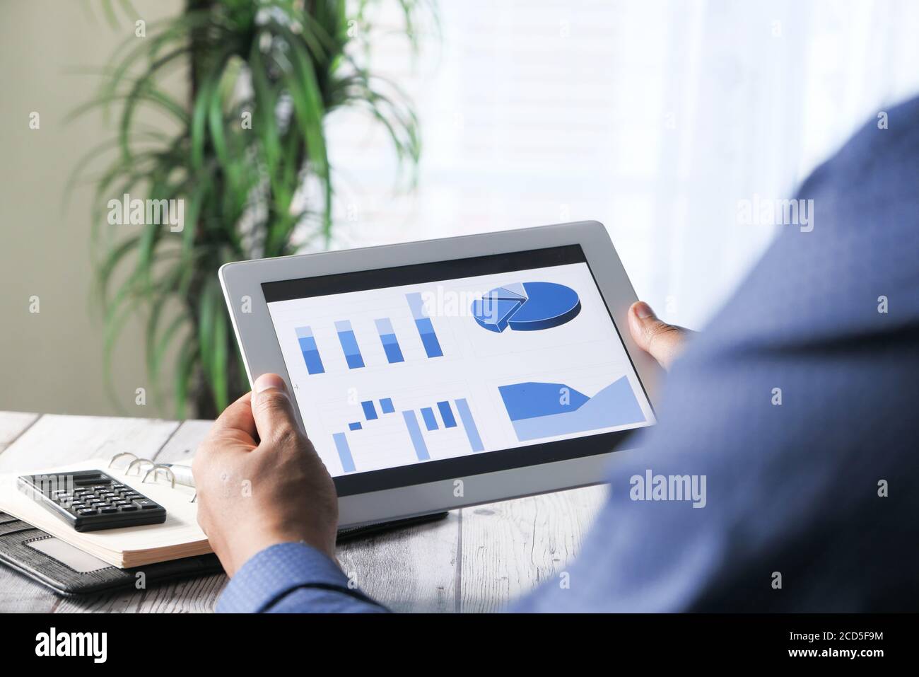 man's hand working on digital tablet at office desk, using self created ...