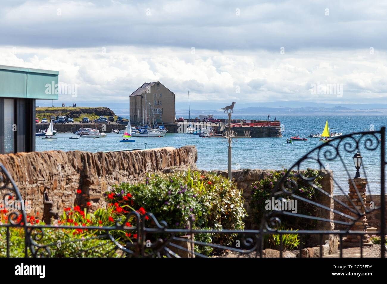 Looking over a garden towards Elie harbour on a summers day. Stock Photo