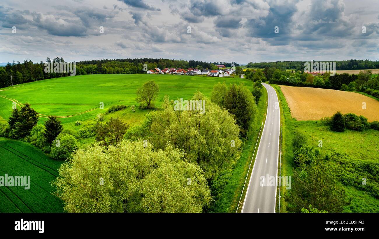 Aerial view of road between fields Stock Photo