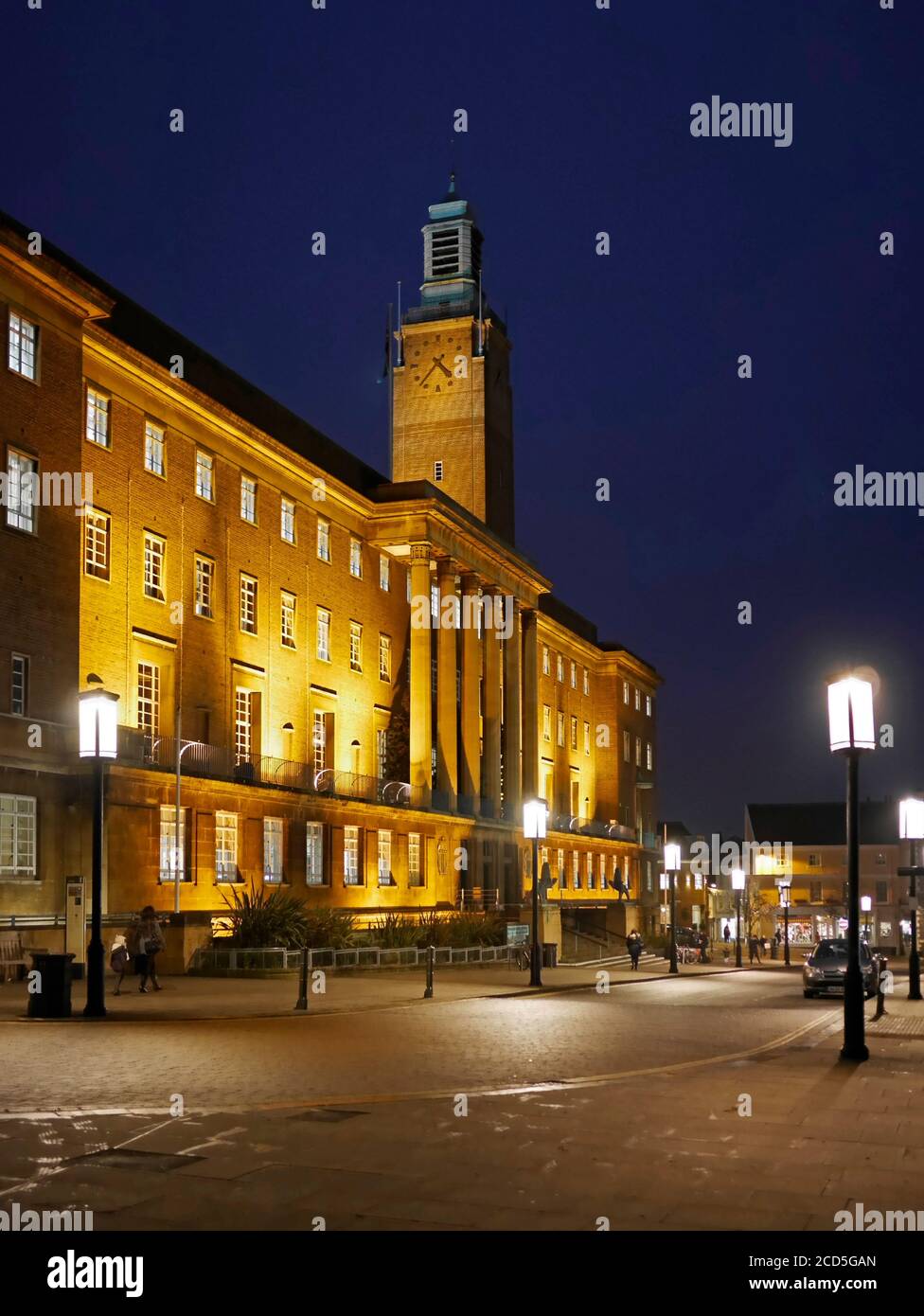 Norwich City Hall with its Clock Tower and lit outside lanterns, floodlit at night, Norwich, Norfolk, England, UK Stock Photo