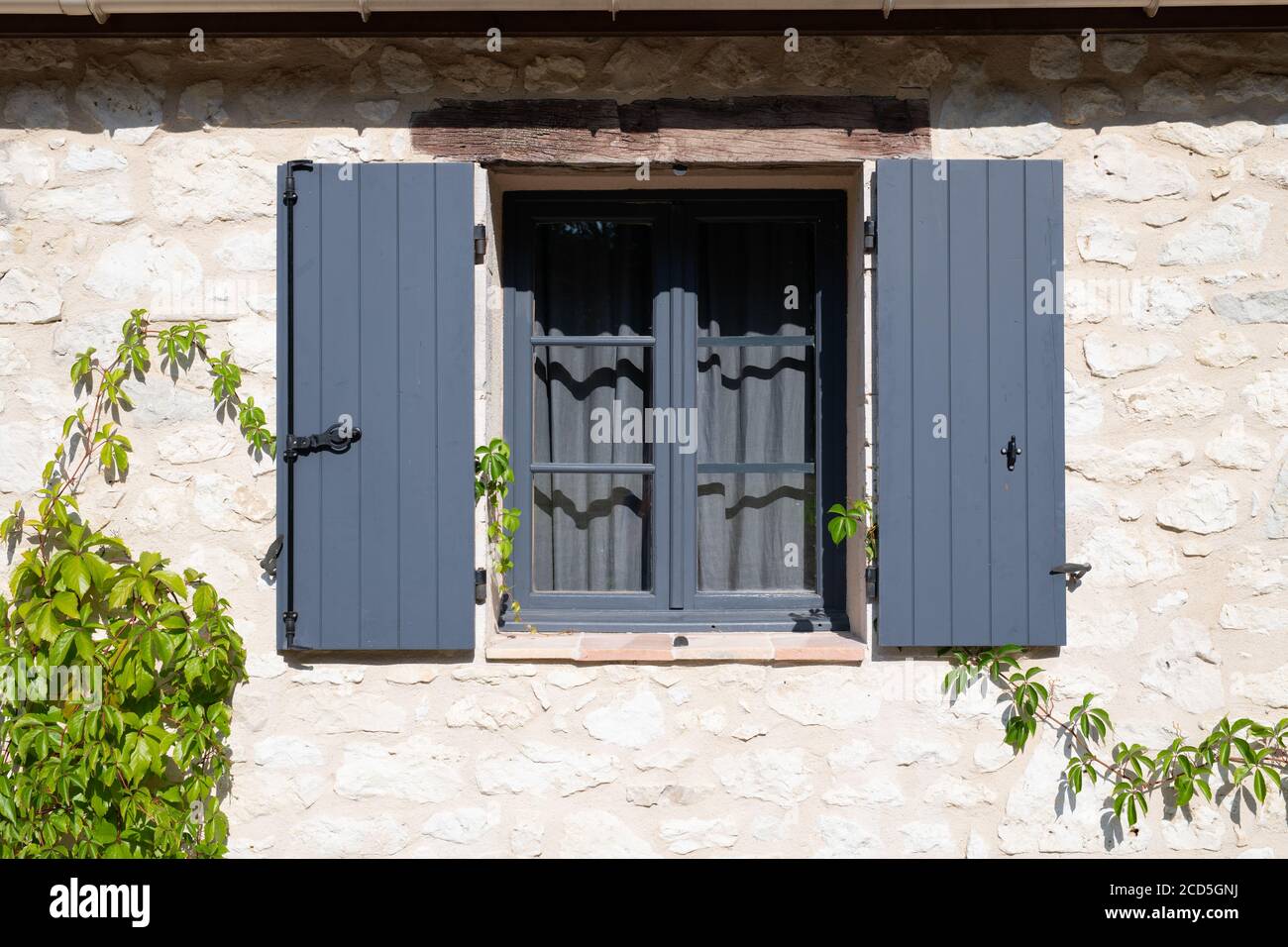 Open wooden window shutters on a french farm house Stock Photo