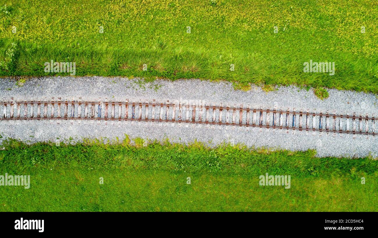 Aerial view of single railroad track through green fields Stock Photo