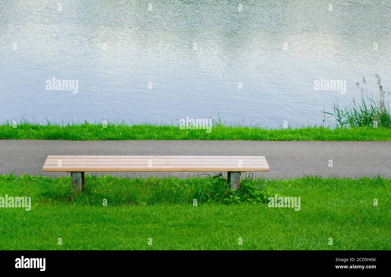 Wooden bench at Bavarian lake, Germany Stock Photo