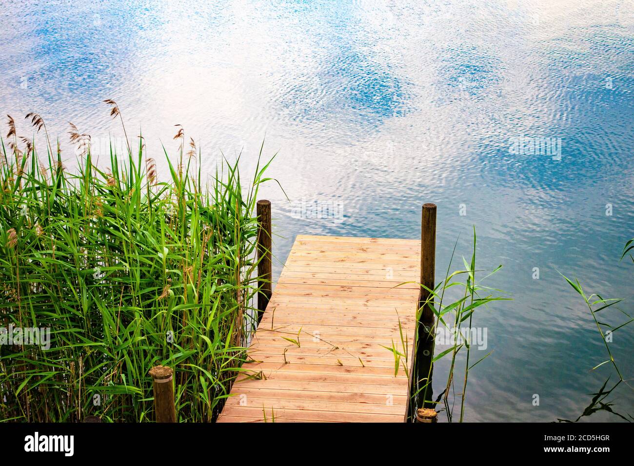 Wooden swimming platform at Bavarian lake in springtime, Germany Stock Photo