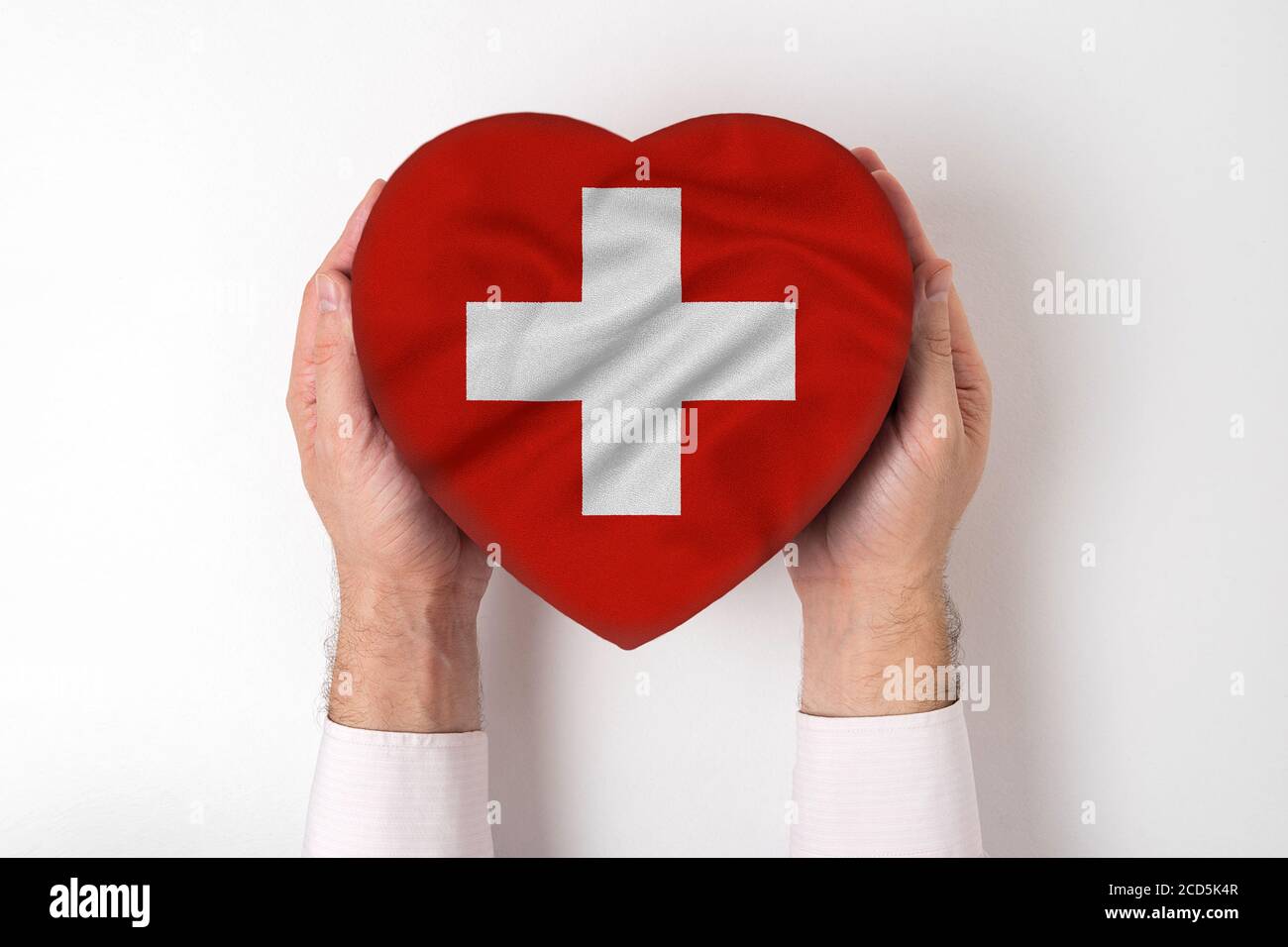 Flag of Switzerland on a heart shaped box in a male hands. White background  Stock Photo - Alamy