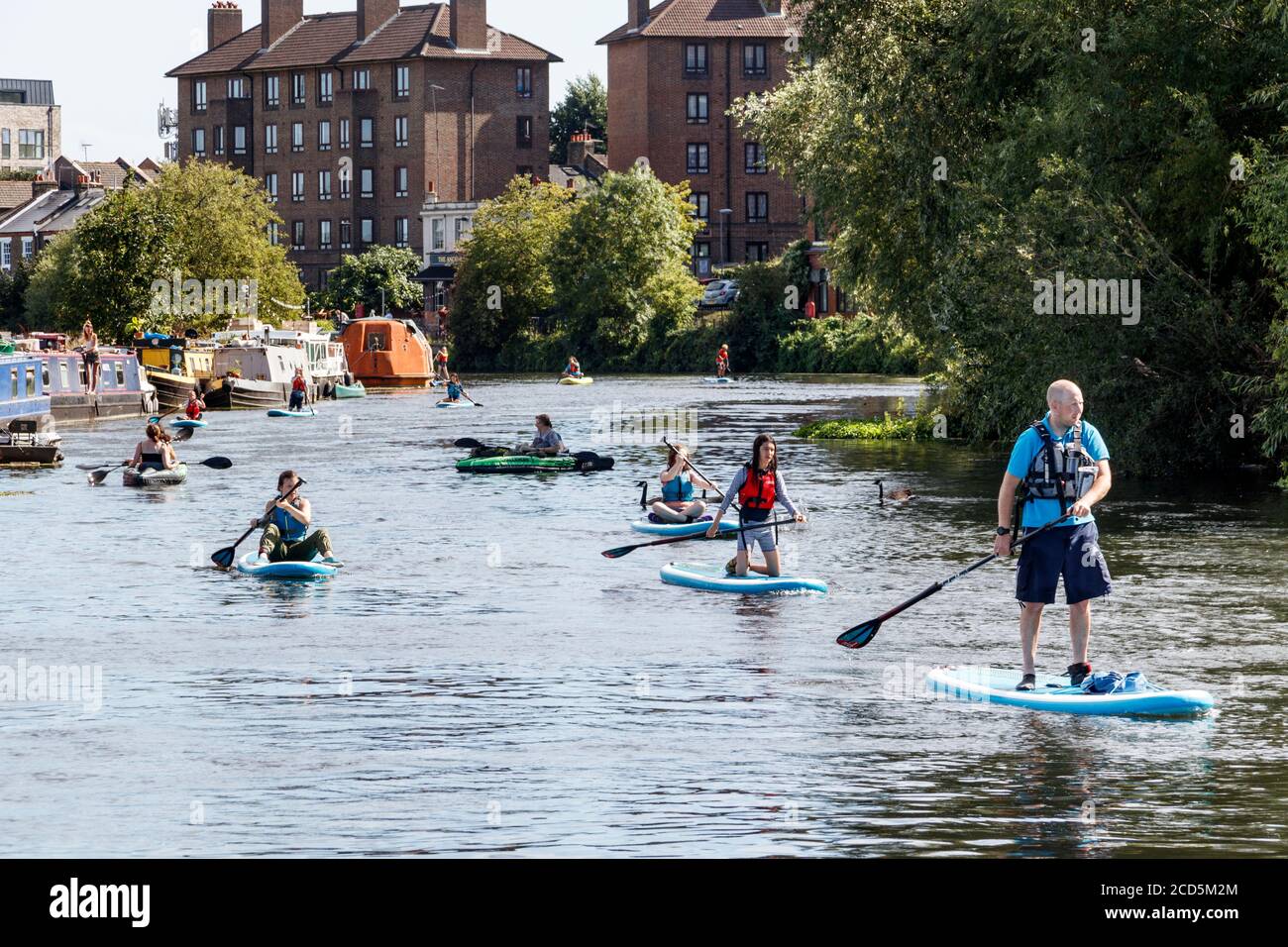 Paddleboarders and kayakers on the River Lea at Clapton, London, UK Stock Photo