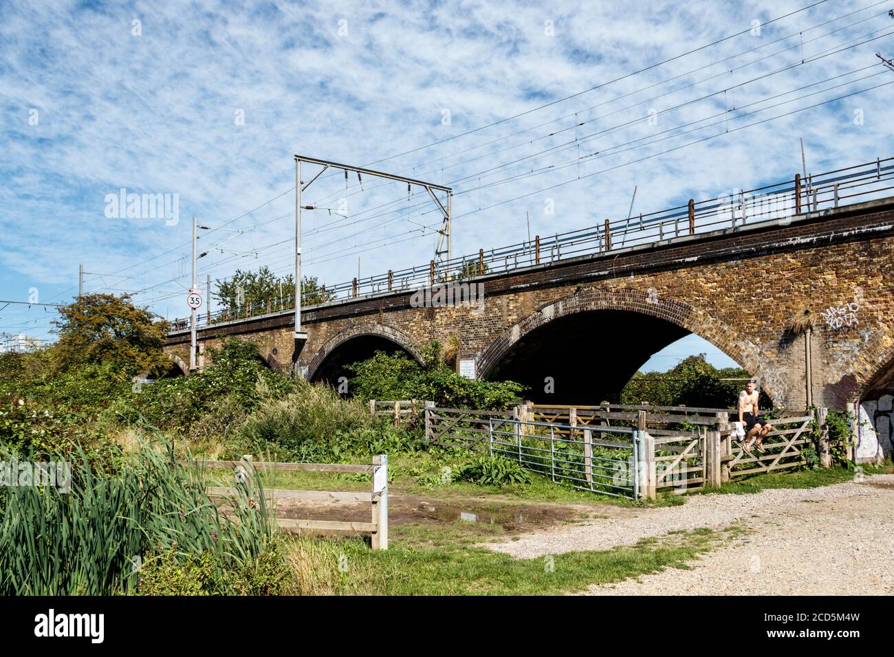 A brick viaduct carrying the railway line across the Walthamstow Marshes, Clapton, London, UK Stock Photo