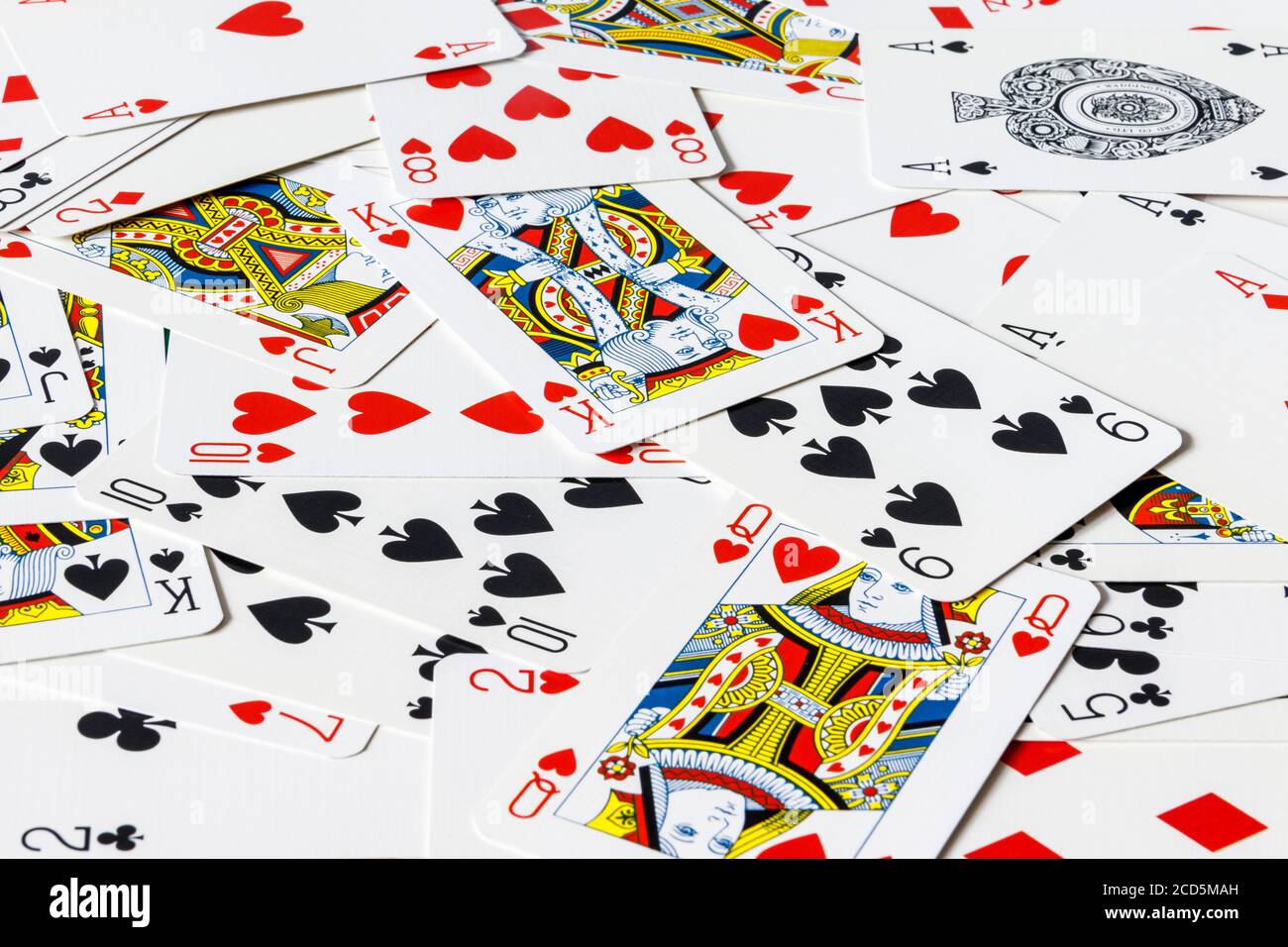 A pack of cards scattered on a table Stock Photo