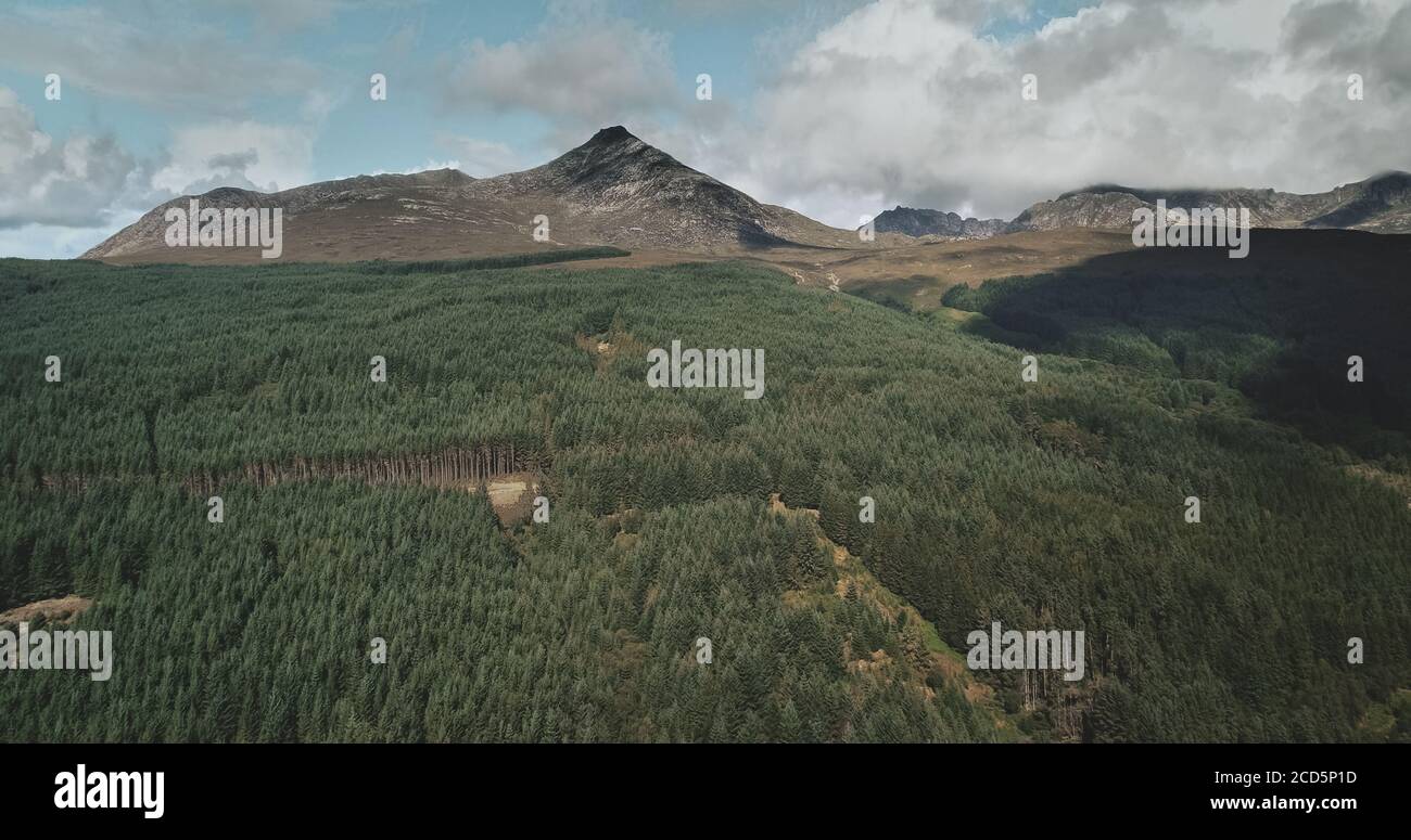 Scotland mountain Goatfell landscape aerial panoramic view at Brodick Harbour, Arran Island. Majestic Scottish nature scenery of forests, meadows and medieval castle shot Stock Photo