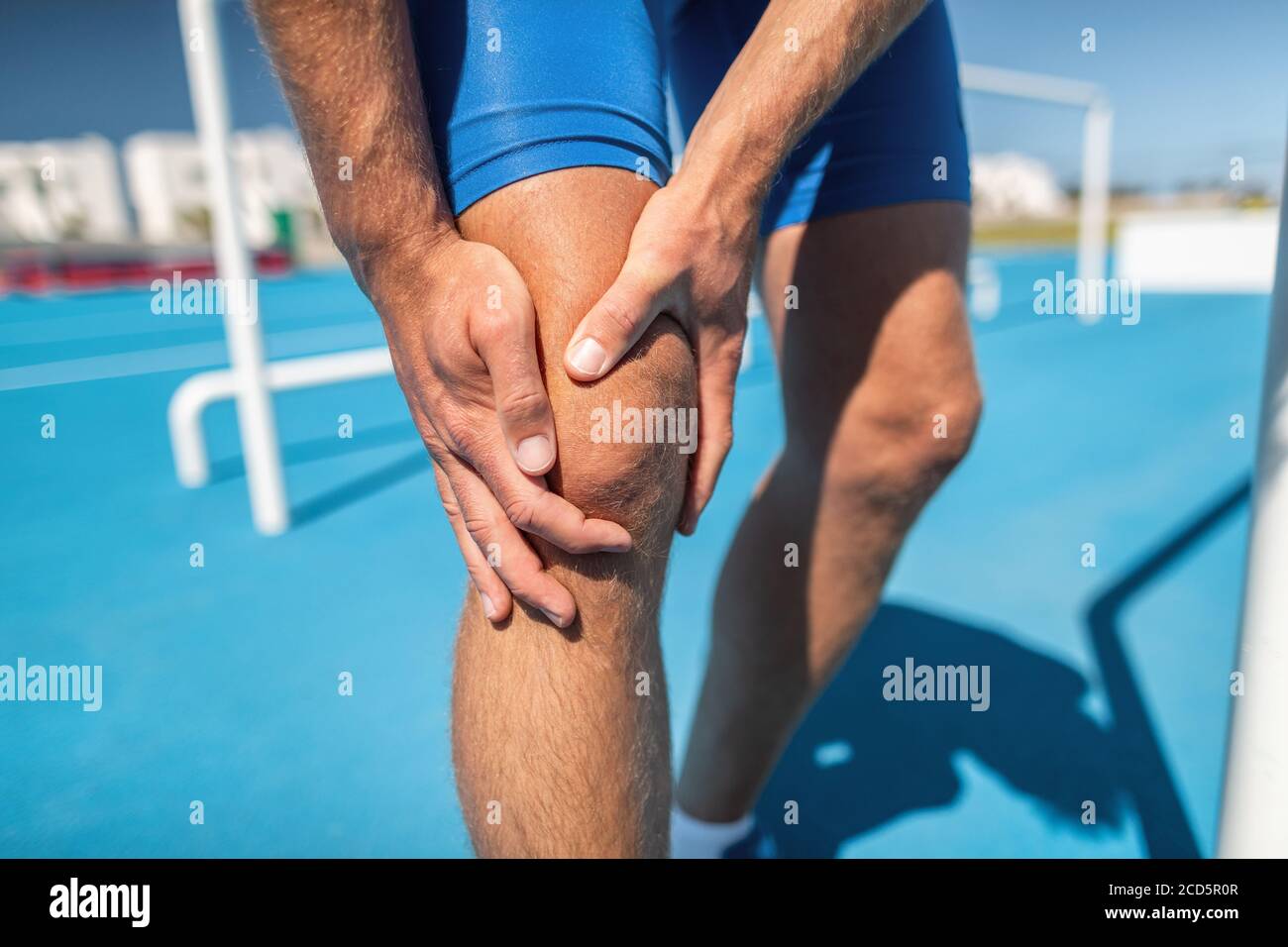 Knee pain professional athlete sport injury - sports running knee acciden on man runner. Sprained knee joint, arthritis. Closeup of legs, muscle and Stock Photo