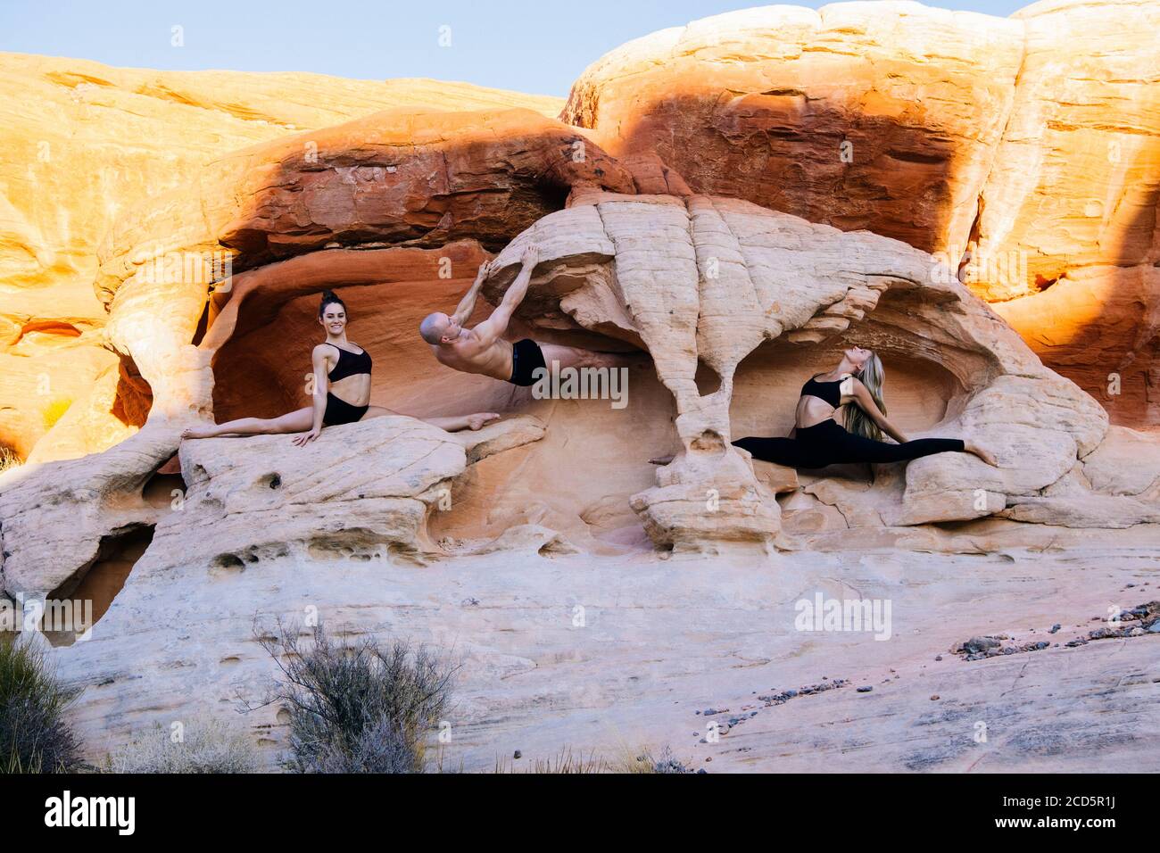 Group of three gymnasts in desert,  State Park, Overton, Nevada, USA Stock Photo