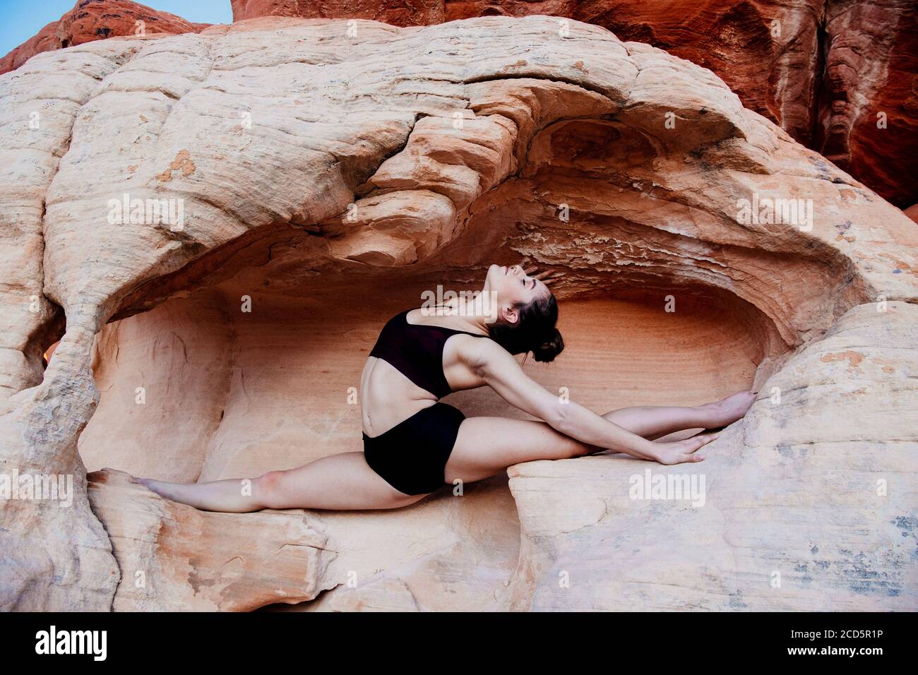 Female gymnast in desert,  State Park, Overton, Nevada, USA Stock Photo