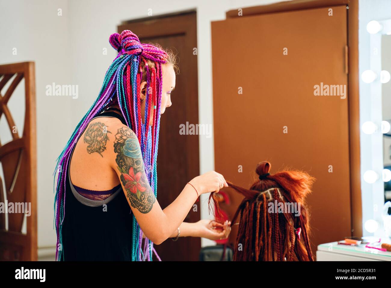 Barber braids dreadlocks. African braids are gathered in the tail