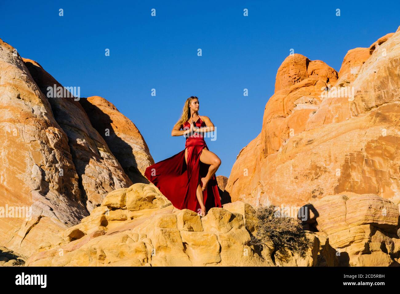 Woman on rock formation, Aztec Sandstone,  State Park, Mohave Desert, Overton, Nevada, USA Stock Photo