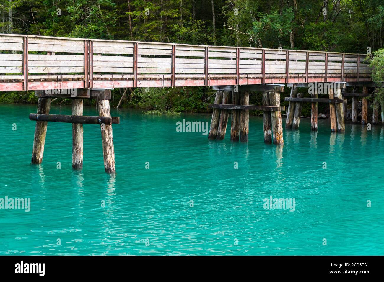 Bridge over turquoise water of Plansee in Austria, summer evening Stock Photo
