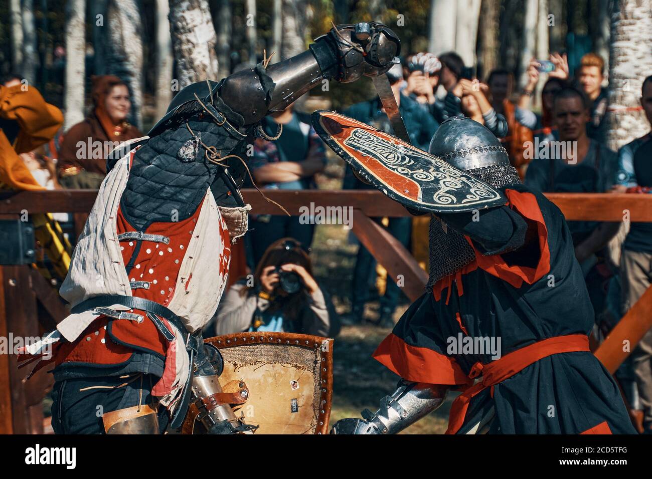 Two knights fight with swords. Reconstruction of a medieval battle in