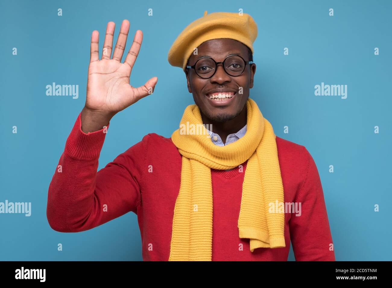 Inspired african man waving hand greeting his friends. Stock Photo