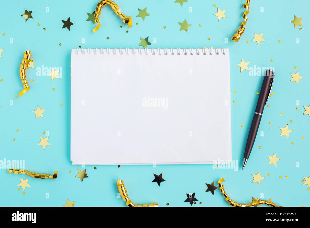 Holiday decorations and open notebook with gold confetti Stock Photo