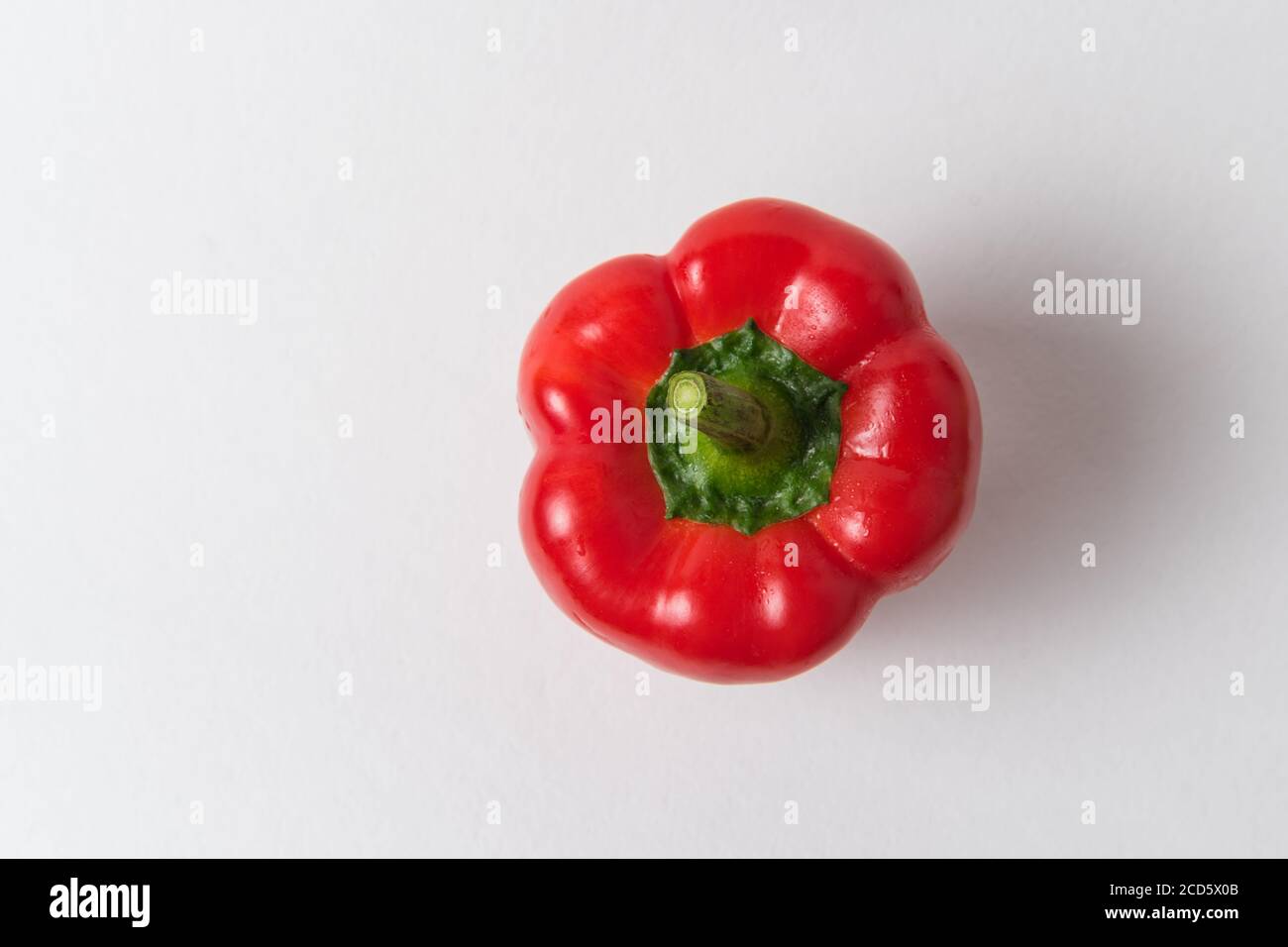 Fresh raw red pepper on a white background. Top view of bell peppers Stock Photo