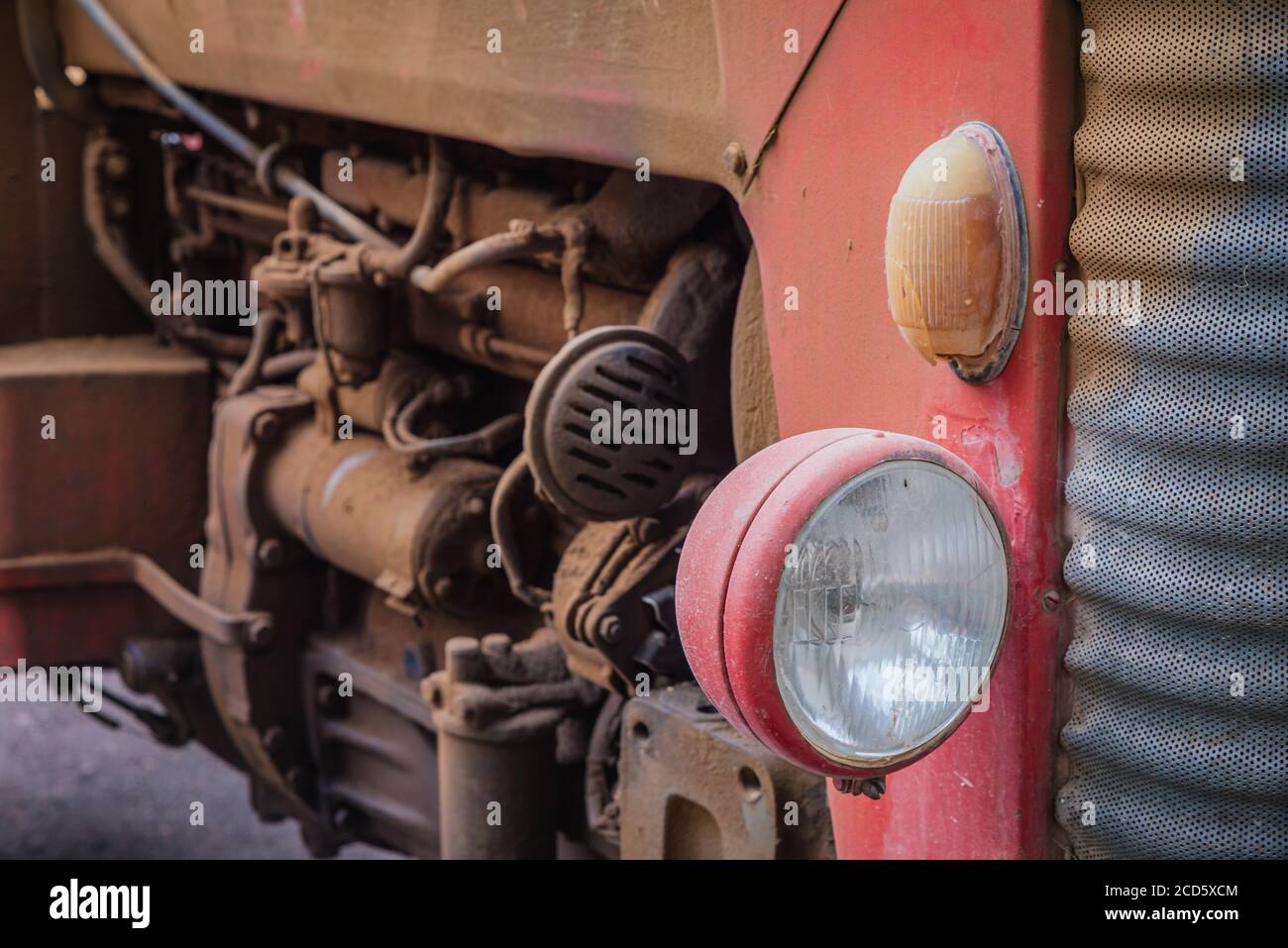 Old vintage red tractor parked at the garden Stock Photo - Alamy
