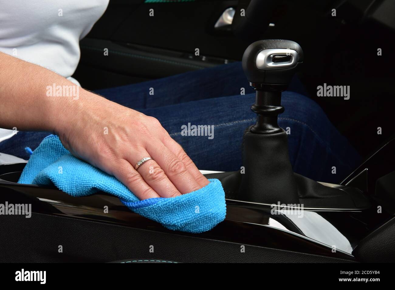 Cleaning the car console with a microfiber cloth Stock Photo - Alamy