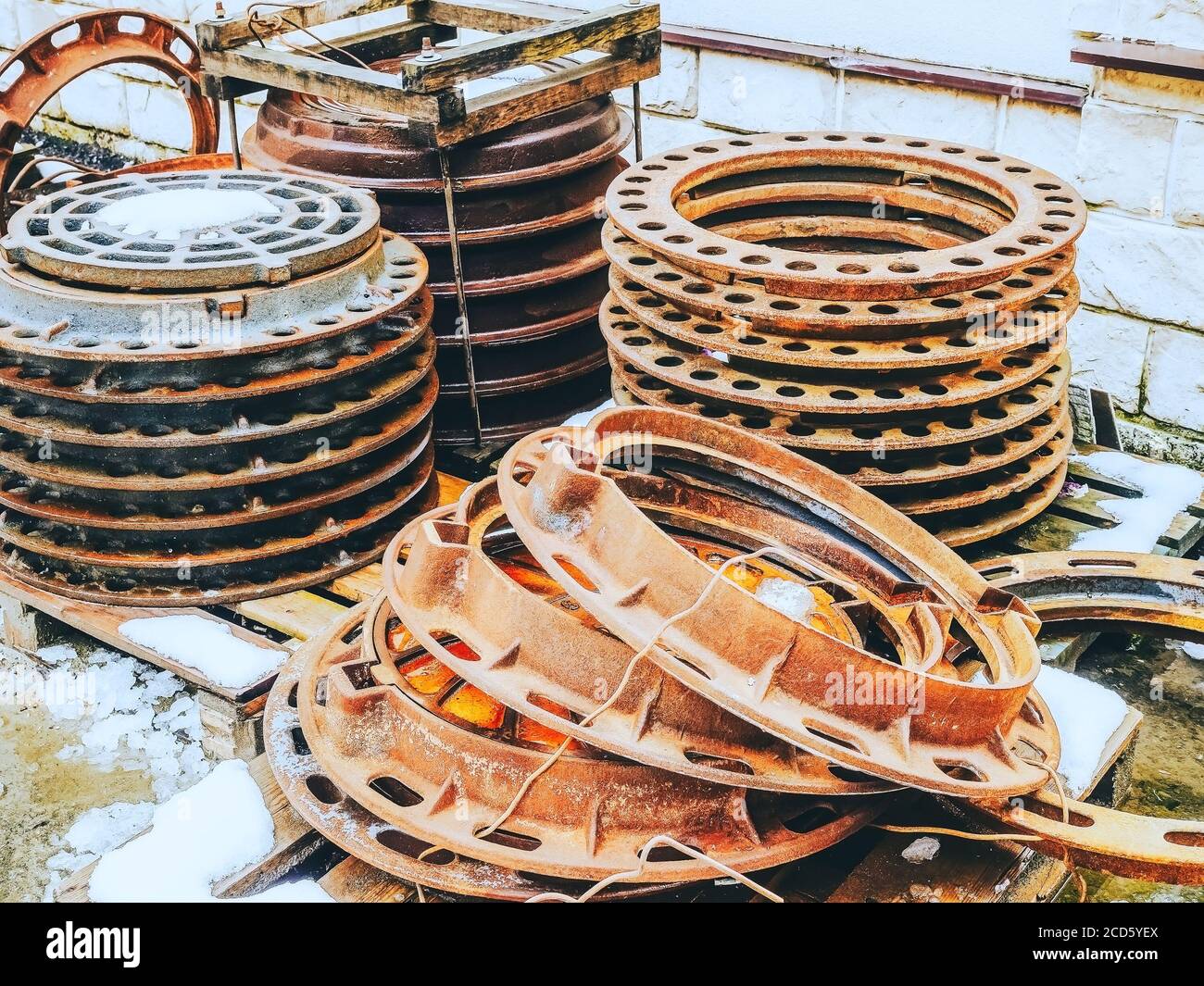 Cast iron rusty hatches stacked in several rows on top of each other