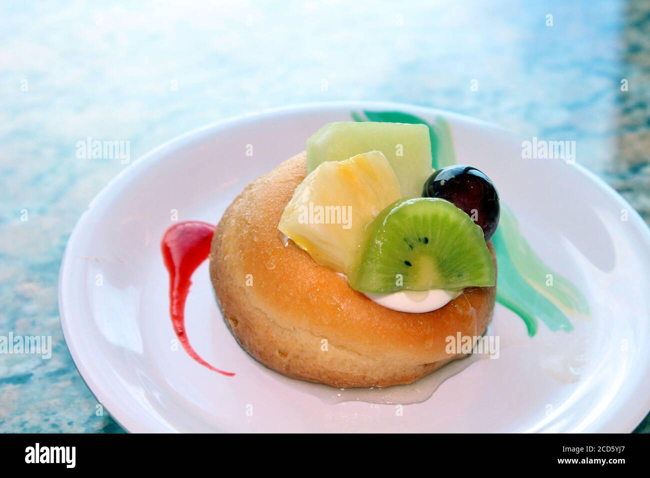 Cake dessert with kiwi, pineapple, and grapes Stock Photo