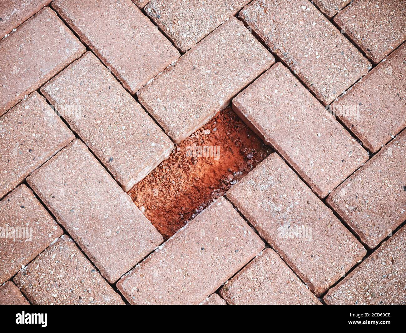 Red paving slabs with one missing piece. Close-up photo Stock Photo - Alamy