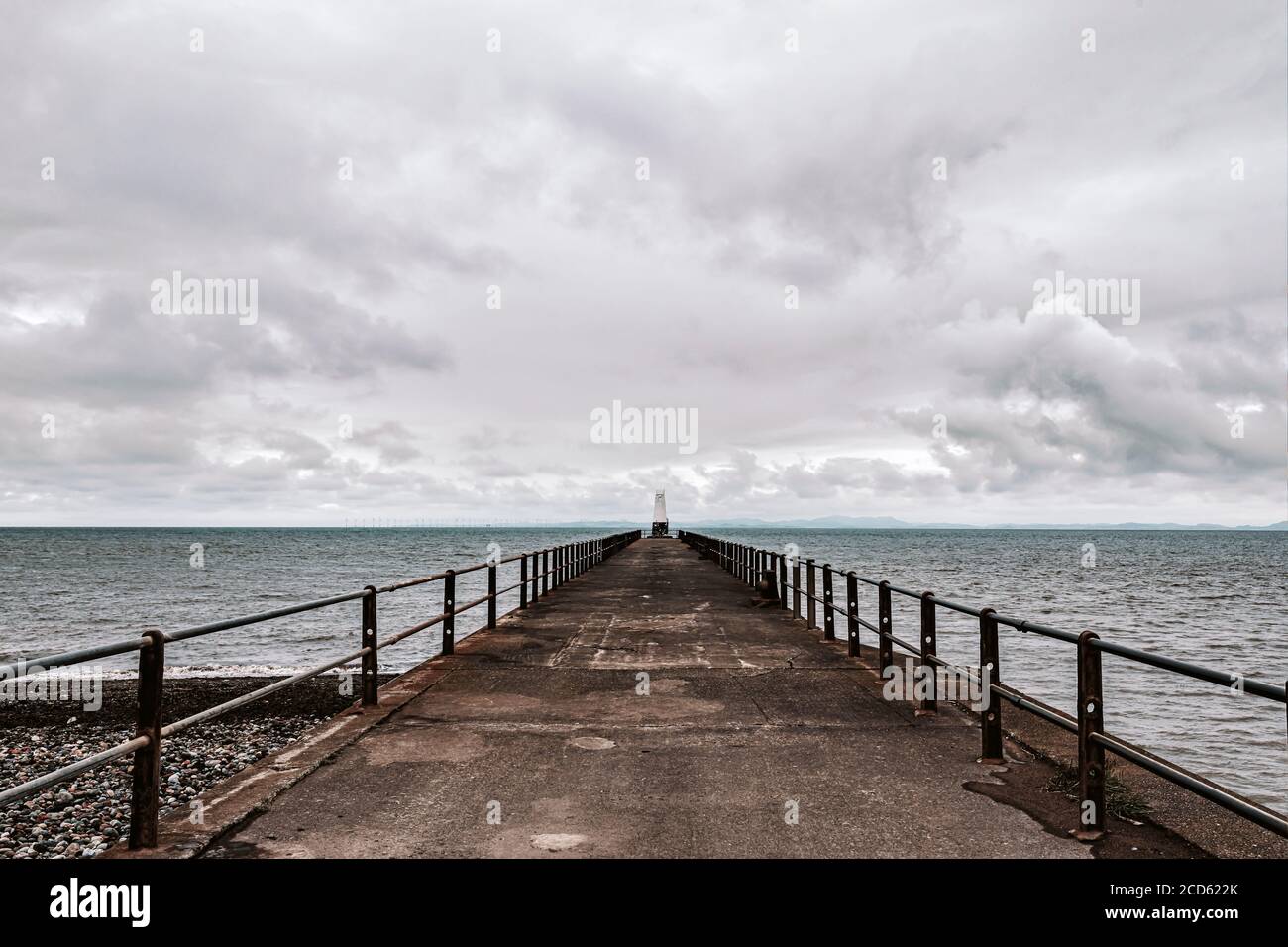The pier at Maryport with lighthouse at the end Stock Photo