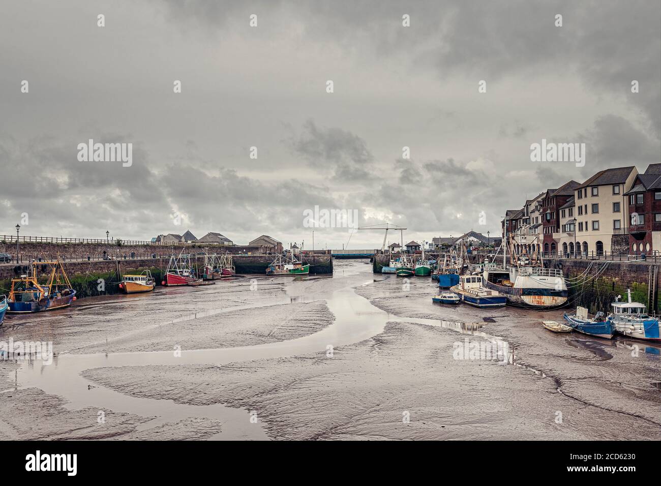 Fishing boats in the harbour at Maryport at low tide Stock Photo